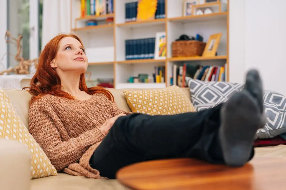 A woman on her couch breathing clean air