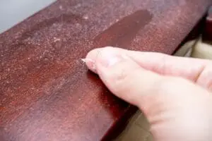 FAQs - Ambient Edge finger wiping layer of dust off wooden surface