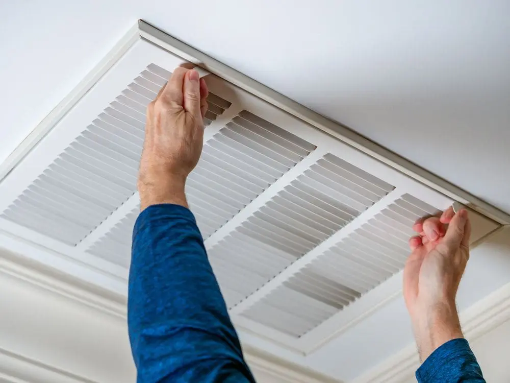 repair technician opening air vent