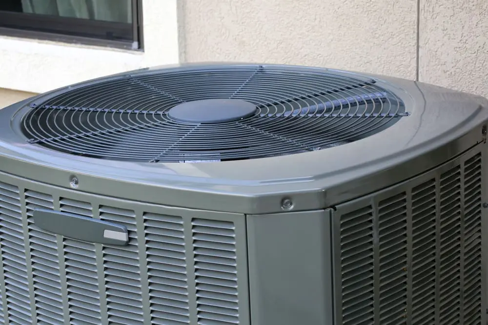 How to Reset AC Unit: Helpful Tips, Steps, and FAQs - Ambient Edge air conditioner’s condenser unit outside residence