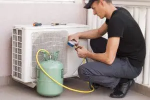 FAQs - Ambient Edge air conditioner repairman fixing a freon leak