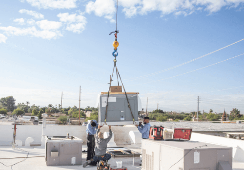 commercial installation of an ac unit on a flat top roof