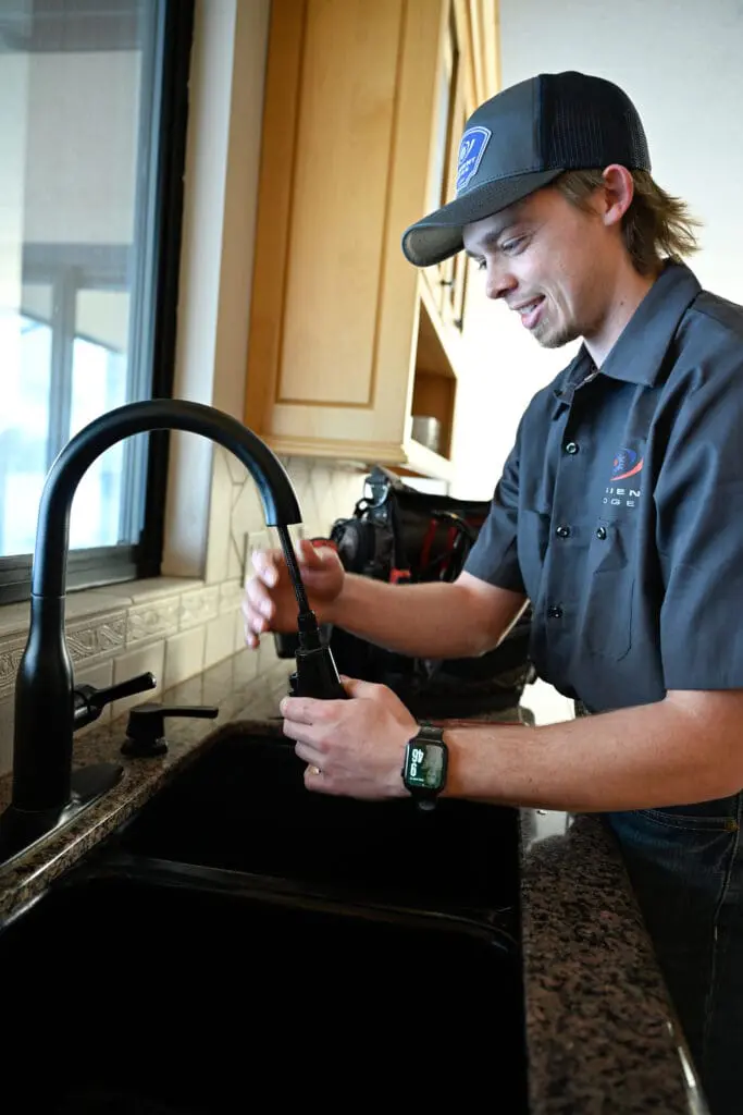 ambient edge plumber working on a faucet