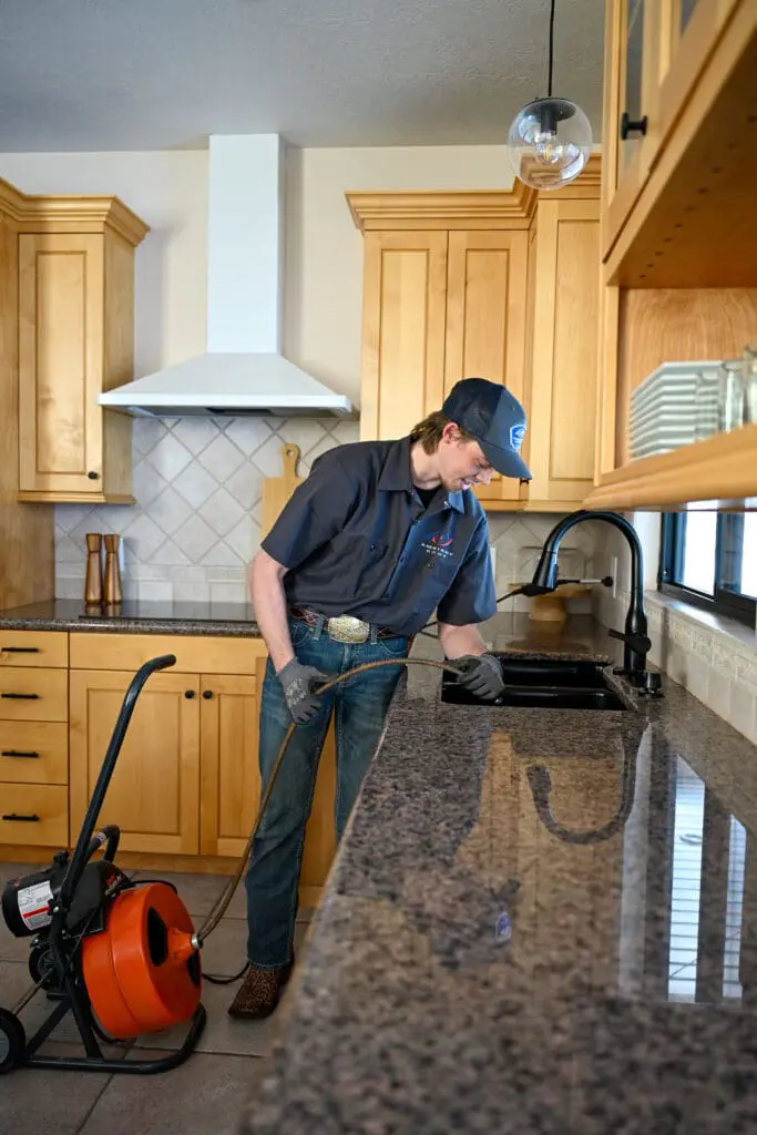 Ambient Edge plumber clearing a drain