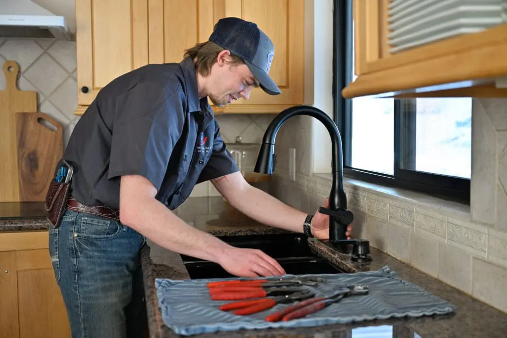 ambient edge plumber working on a sink