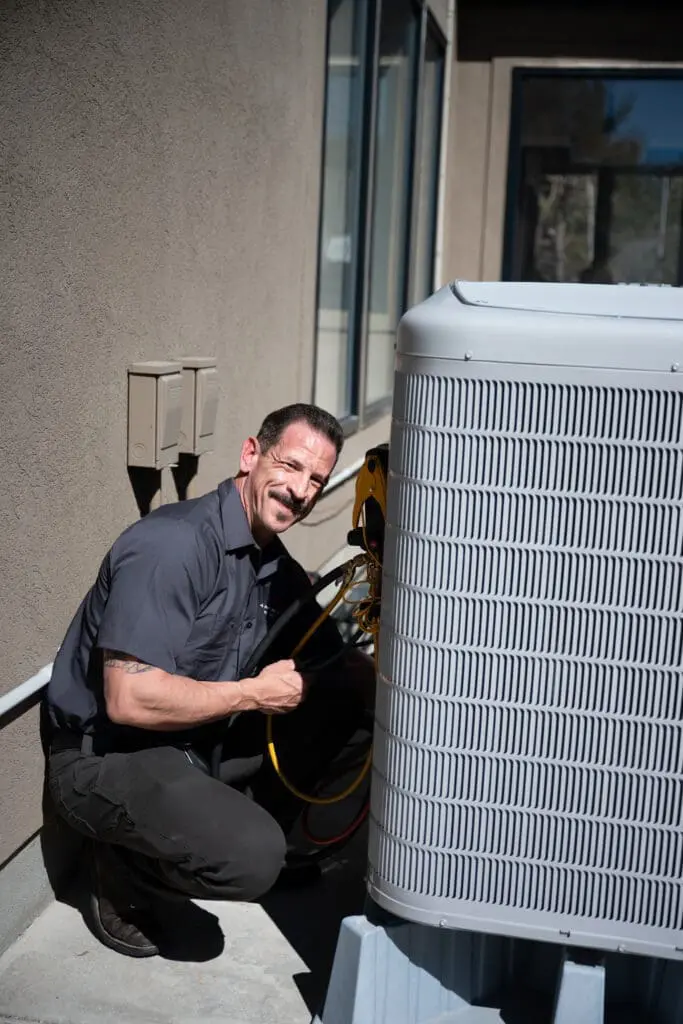 Ambient Edge employee posing with an ac unit