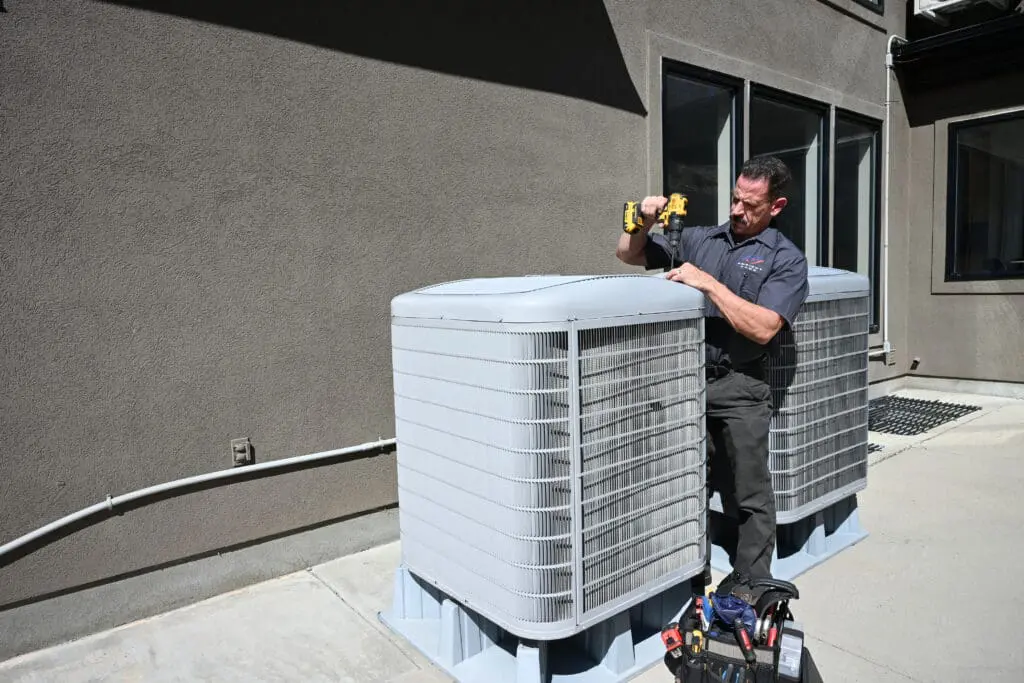 ambient edge employee working on an ac unit