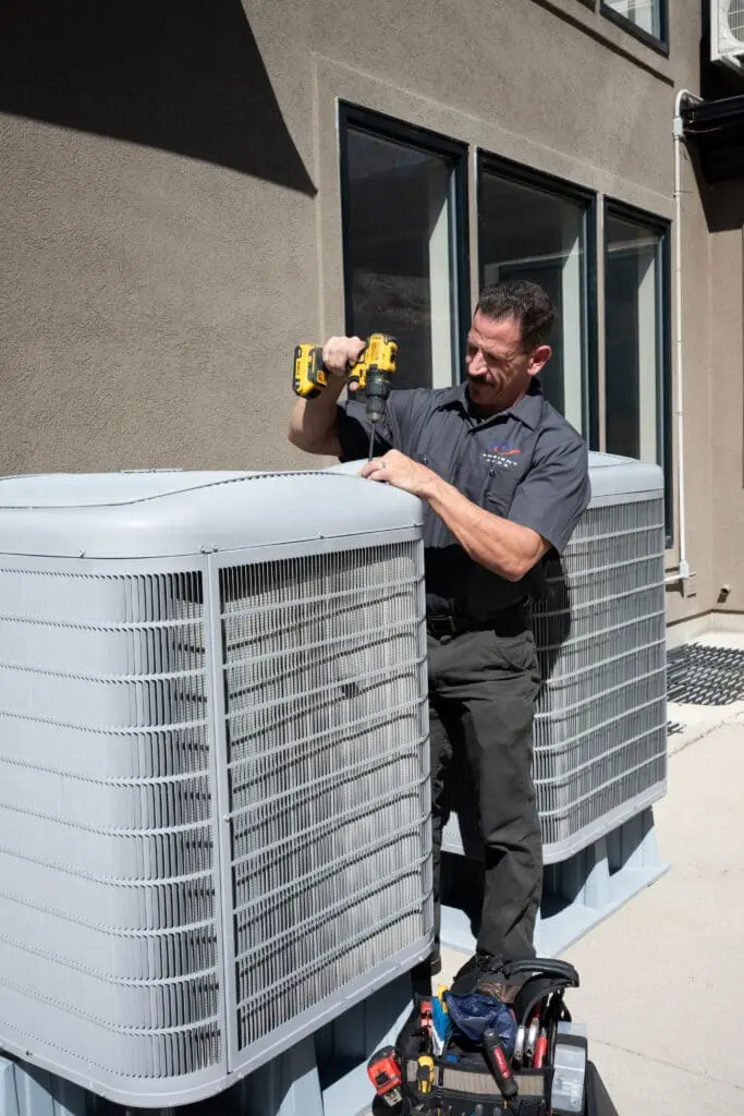 Ambient Edge employee operating on an ac unit