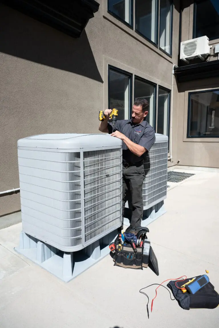 Ambient edge employee working on a heat pump