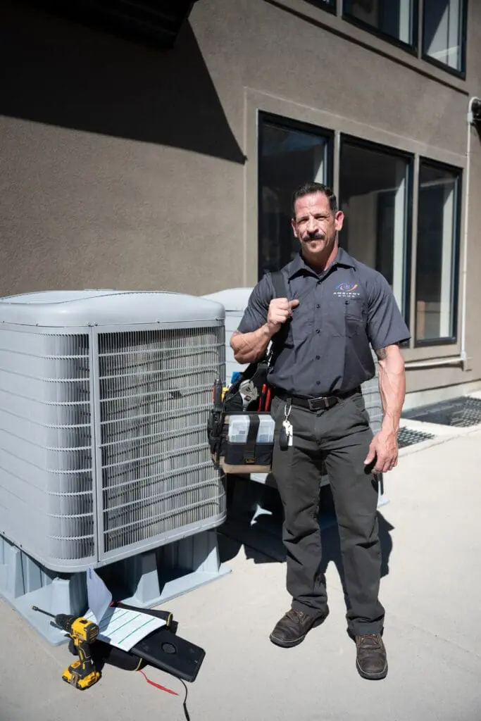 ambient edge employee posing in front of an ac unit