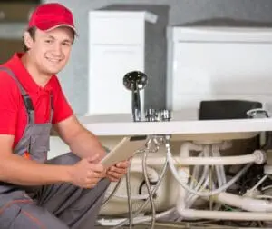 plumber checking bathroom pipes