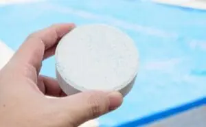 person holding a chlorine tablet