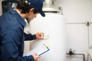 person inspecting a water heater