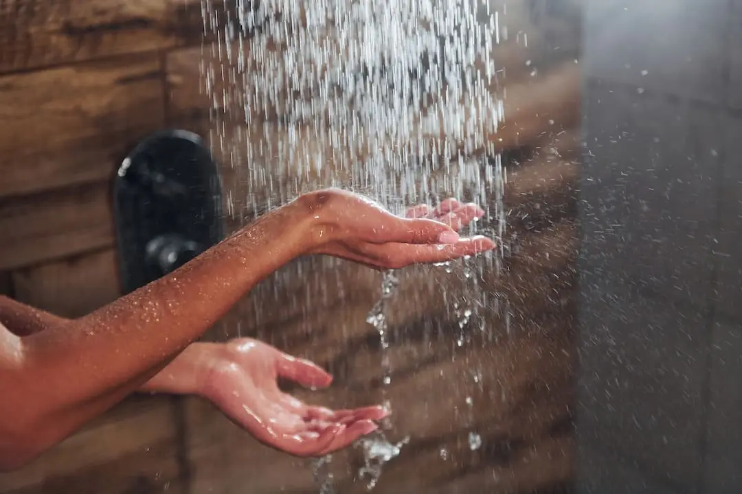 Close up view of hands of woman that taking a shower in spa