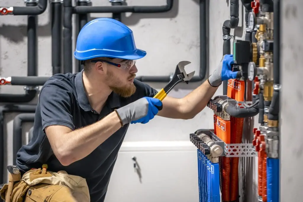 plumbing technician with a wrench