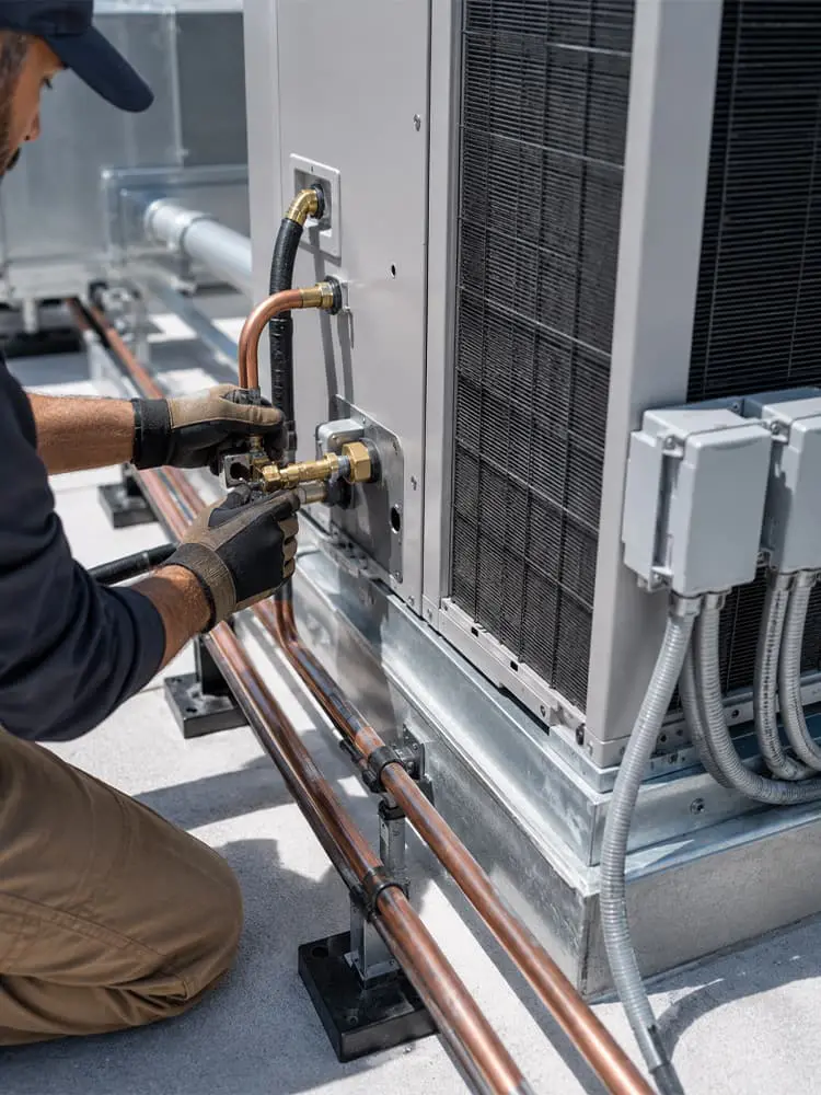 technician installing a commercial ac unit
