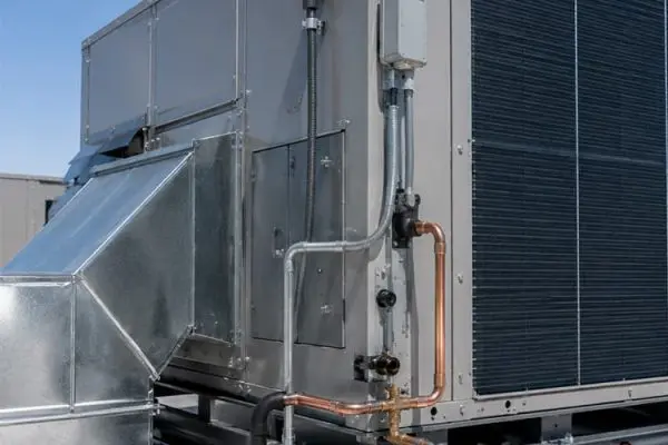 Commercial rooftop air conditioning unit installed in Bullhead City AZ with visible ductwork, copper piping, and electrical connections.