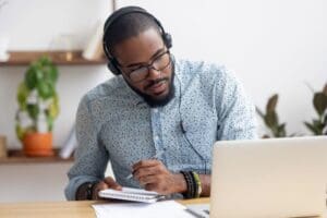 A man does research on a laptop.
