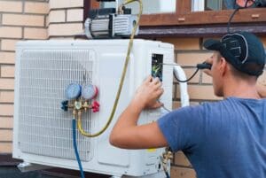 technician performing maintenance to outdoor air conditioning unit