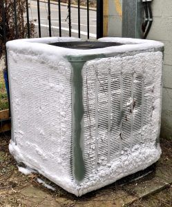 outdoor ac unit coated with ice