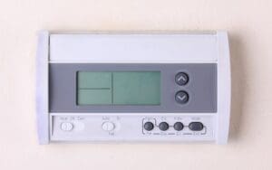digital wall-mounted thermostat with button controls