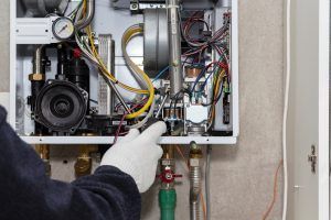 hvac repair technician servicing gas boiler