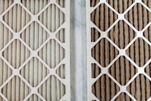 side-by-side close-up view of new and used air filters