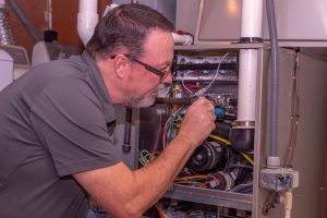 technician repairs heating system