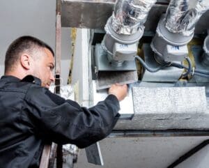 Technician installing HVAC system.