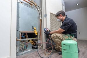 technician checks refrigerant levels.