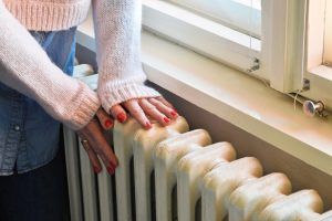 woman checks home heater