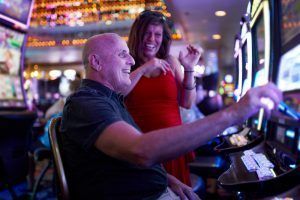 couple enjoys casino slot machine