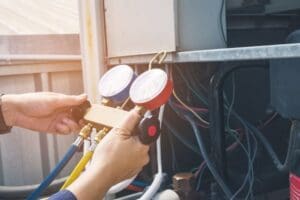 technician repairs apartment building’s hvac unit