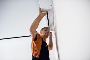 experienced technician installs replacement AC