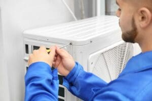 technician installs outdoor ac unit