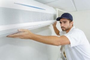 technician-installs-replacement-ac-unit