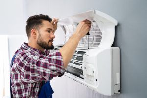 HVAC-maintenance-technician-performs-AC-repair