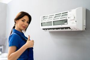 AC replacement technicians completes air conditioner installation
