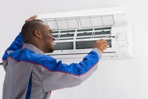 HVAC technician installs replacement AC unit