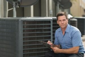 ac And Heating Maintenance Technician by a Cooling Unit