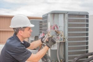 hvac technician working on capacitor