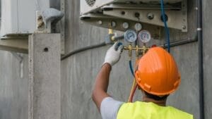 technician-checking-outdoor-air-conditioner-unit