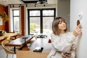 woman controlling home temperature