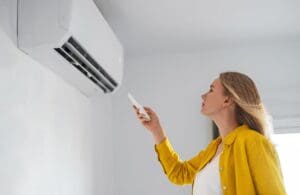 woman uses air conditioner mini split