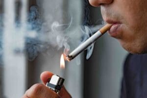 man lighting up a cigarette