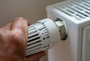man regulating temperature on a heater