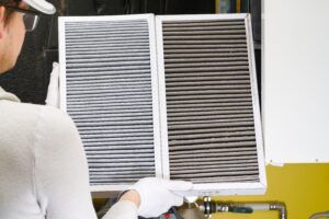 HVAC tech replacing AC filter
