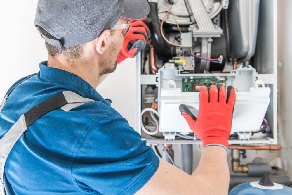 Heating and Furnace Installation Company in Spring Valley, NV - Ambient Edge echnician working on gas furnace