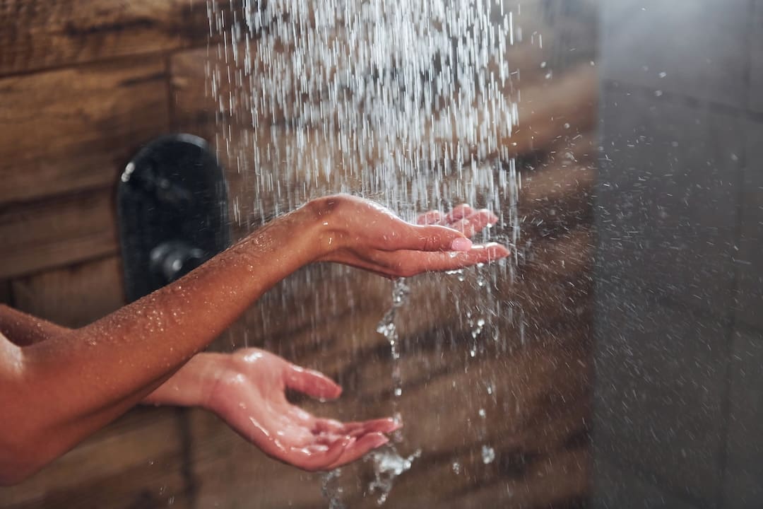 Close up view of hands of woman that taking a shower in spa