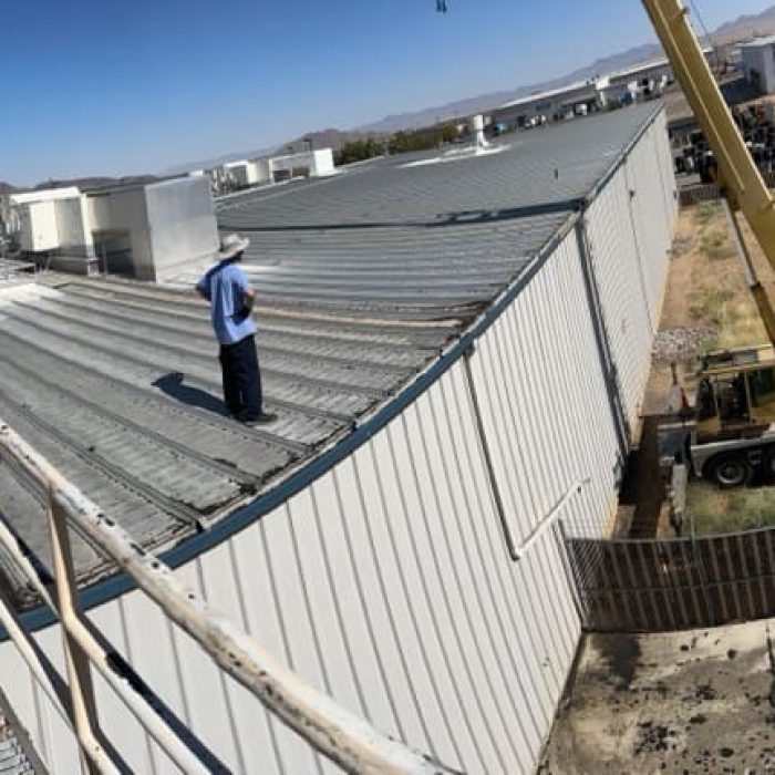 person standing on a commercial flat top roof